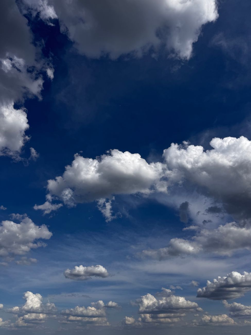 A vivid and dramatic sky filled with cumulus clouds over Budapest, Hungary.